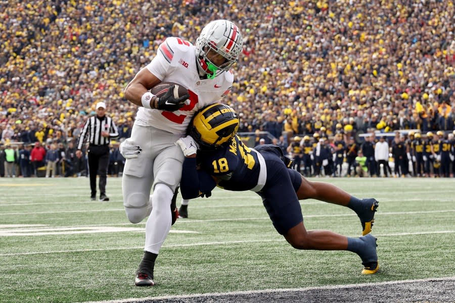 ANN ARBOR, MICHIGAN – NOVEMBER 25: Emeka Egbuka #2 of the Ohio State Buckeyes scores a touchdown against Ja’Den McBurrows #18 of the Michigan Wolverines during the second quarter in the game at Michigan Stadium on November 25, 2023 in Ann Arbor, Michigan. (Photo by Ezra Shaw/Getty Images)