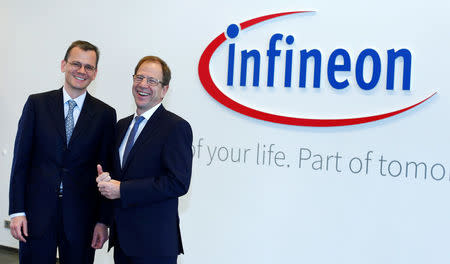 Reinhard Ploss (R), CEO of German semiconductor manufacturer Infineon, and CFO Dominik Asam pose before the annual news conference in Munich, Germany, November 23, 2016. REUTERS/Michaela Rehle