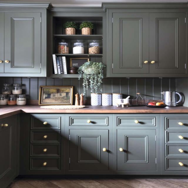 grey cabinets and drawers with wooden worktops and flooring