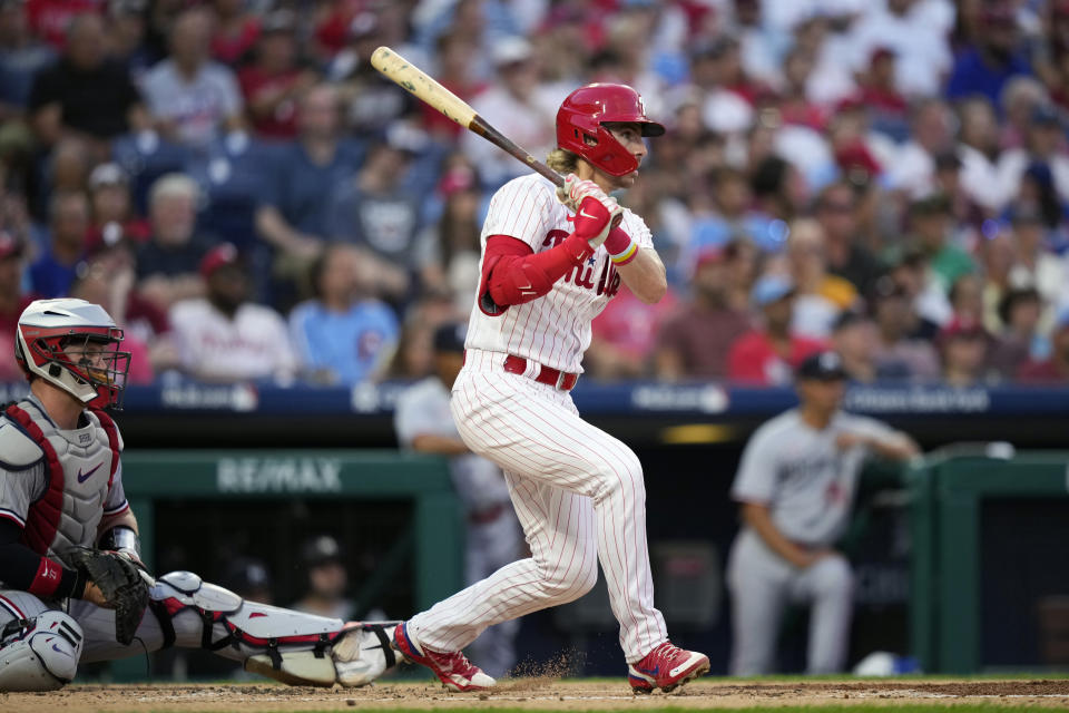 Philadelphia Phillies' Bryson Stott follows through after hitting a run-scoring double against Minnesota Twins pitcher Dallas Keuchel during the second inning of a baseball game, Friday, Aug. 11, 2023, in Philadelphia. (AP Photo/Matt Slocum)