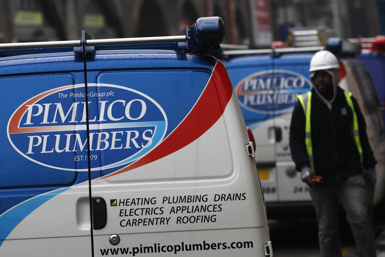 A worker walks past a Pimlico Plumbers van in London, Britain February 10, 2017. REUTERS/Stefan Wermuth