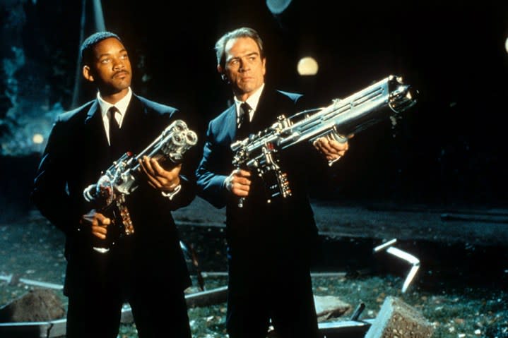 The men in black point alien guns.