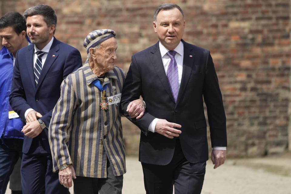 CAPTION CORRECTS THE NAME - Poland's President Andrzej Duda, right, and Auschwitz Survivor from U.S. Edward Mosberg, attend the March of the Living annual observance that was not held for two years due to the global COVID-19 pandemic, in Oswiecim, Poland, Thursday, April 28, 2022. Only eight survivors and some 2,500 young Jews and non-Jews are taking part in the annual march that is scaled down this year because of the war in neighboring Ukraine that is fighting Russia's invasion. (AP Photo/Czarek Sokolowski)