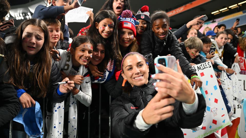 US forward Alex Morgan  takes a selfie with fans at Eden Park on August 1, 2023. - Hannah Peters/FIFA/Getty Images