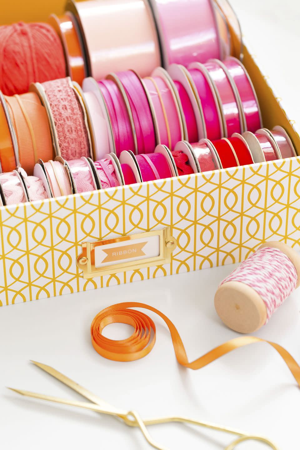 <p>Unless you're an avid crafter, you probably don't bust out your ribbon stash on the daily. Before <a href="https://www.goodhousekeeping.com/holidays/gift-ideas/tips/g1775/diy-holiday-gift-wrap/" rel="nofollow noopener" target="_blank" data-ylk="slk:gift giving season hits;elm:context_link;itc:0;sec:content-canvas" class="link ">gift giving season hits</a>, set up a portable (and pretty!) ribbon station by placing the color-coordinated spools in a shallow box. When it comes to wrap, you can shop through your stash to find what you need. </p><p><a class="link " href="https://www.amazon.com/PHOTO-STORAGE-BOXES-HOLDS-PHOTOS/dp/B003WSV1RI/?tag=syn-yahoo-20&ascsubtag=%5Bartid%7C10063.g.36459111%5Bsrc%7Cyahoo-us" rel="nofollow noopener" target="_blank" data-ylk="slk:SHOP STORAGE BOXES;elm:context_link;itc:0;sec:content-canvas">SHOP STORAGE BOXES</a> </p>
