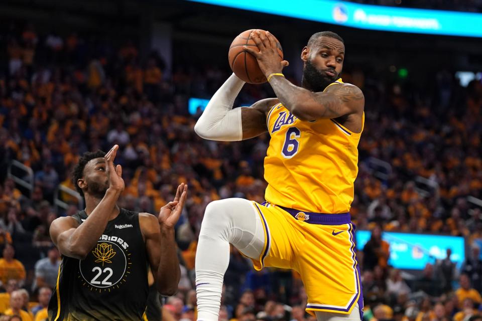 Los Angeles Lakers forward LeBron James (6) grabs a rebound in front of Golden State Warriors forward Andrew Wiggins (22) in the fourth quarter at the Chase Center.