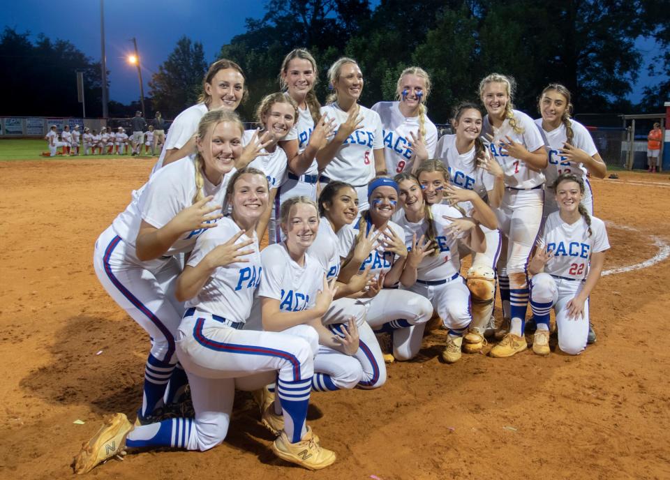 The Patriots pose for photos following their victory in the University vs Pace 6A Regional Final playoff softball game at Pace High School on Friday, May 20, 2022.  The Patriots defeated the Titans 11-0 in the bottom of the 6th inning due to the mercy rule.