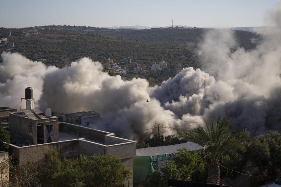 Israeli army forces blow up the family house of Palestinian Yahia Merai in the West Bank town of Qarawat Bani Hassan, Salfit, Tuesday, July 26, 2022. Israeli soldiers demolished the residences of Palestinian attackers Yahia Merai and Youssef Assi who committed the deadly attack in the Israeli settlement of Ariel in April 2022, the Israeli army said. (AP Photo/Nasser Nasser)