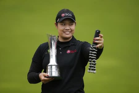Britain Golf - RICOH Women's British Open 2016 - Woburn Golf & Country Club, England - 31/7/16 Thailand's Ariya Jutanugarn takes a picture with a 360 camera after winning the Women's British Open 2016 Action Images via Reuters / Andrew Couldridge Livepic