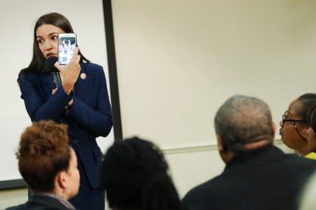 U.S. Rep. Alexandria Ocasio-Cortez (D-NY) listens to a question from an attendee during a town hall in New York