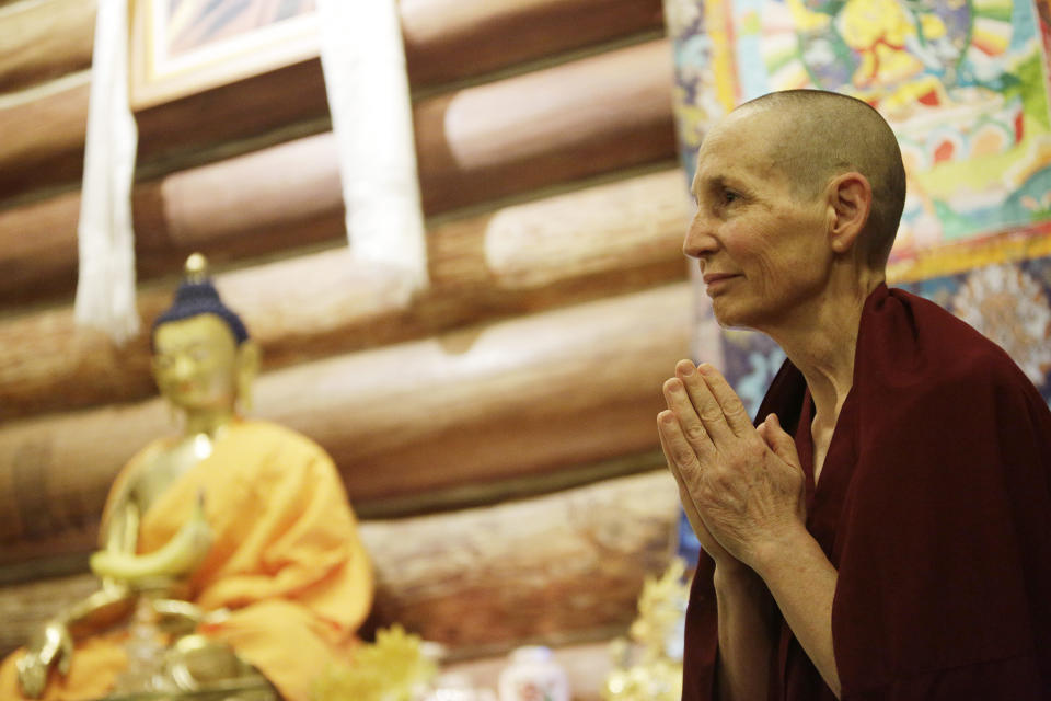 Tenzin Tsepal, a fully ordained Buddhist nun, bows to other residents and guests during morning mediation at Sravasti Abbey, Thursday, Nov. 18, 2021, in Newport, Wash. The abbey is the only Tibetan Buddhist training monastery for Western monks and nuns in America. (AP Photo/Young Kwak)