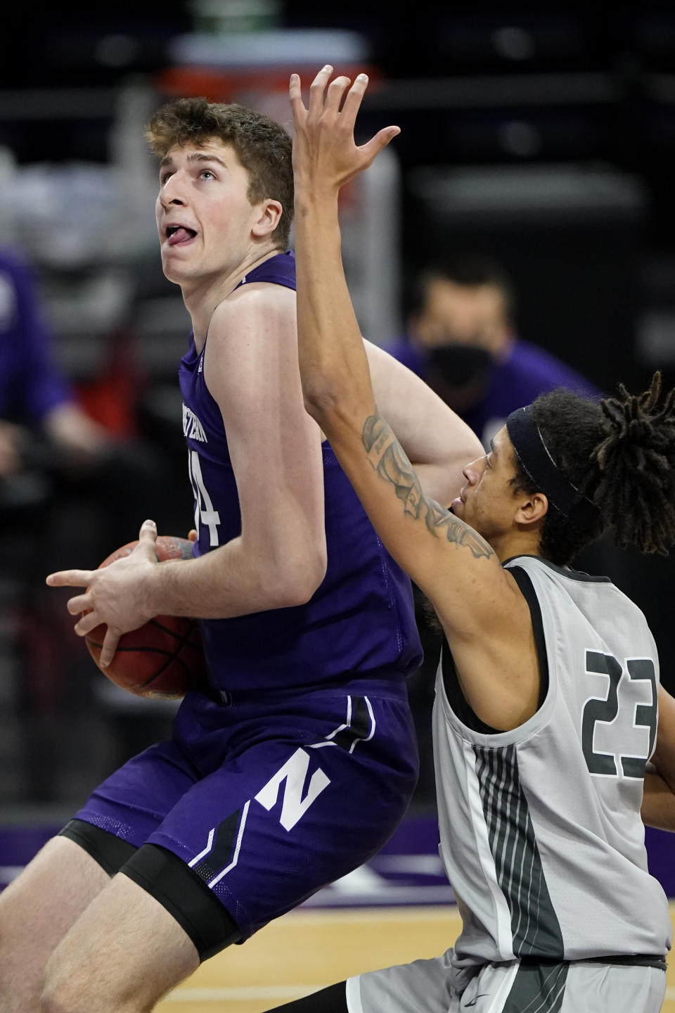 Northwestern center Matthew Nicholson, left, drives to the basket against Chicago State forward Jordan Polynice during the second half of an NCAA college basketball game in Evanston, Ill., Saturday, Dec. 5, 2020. (AP Photo/Nam Y. Huh)