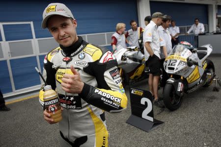 FILE PHOTO - Suter Moto2 rider Thomas Luethi of Switzerland celebrates taking second position after the qualifying session at the Portuguese Grand Prix in Estoril May 5, 2012. REUTERS/Marcos Borga