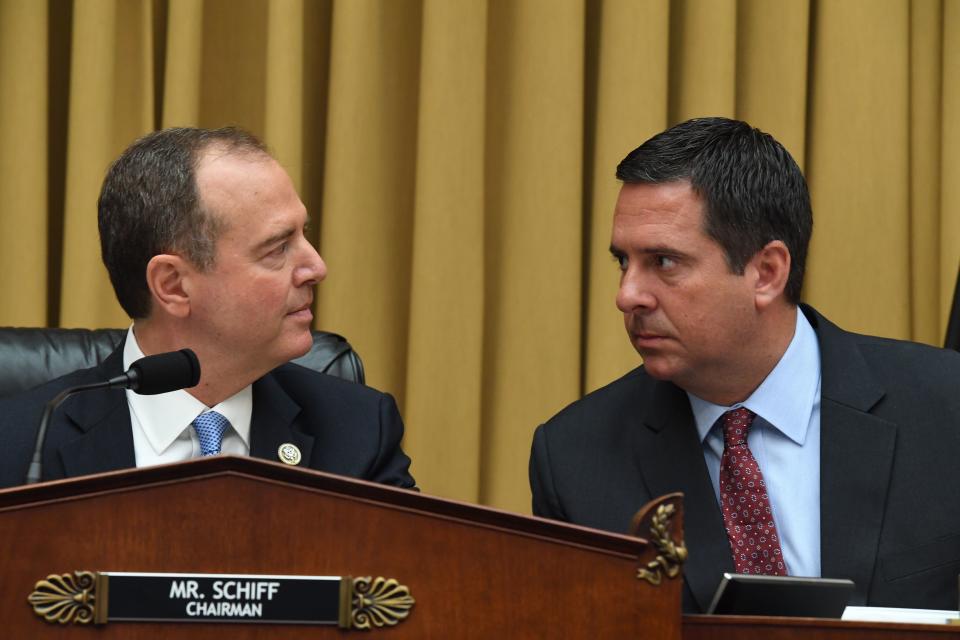 House Intelligence Committee Chairman Adam Schiff speaks with committee member Devin Nunes before former special counsel Robert Mueller testifies on Wednesday. (Photo by Jim Watson/AFP/Getty Images)