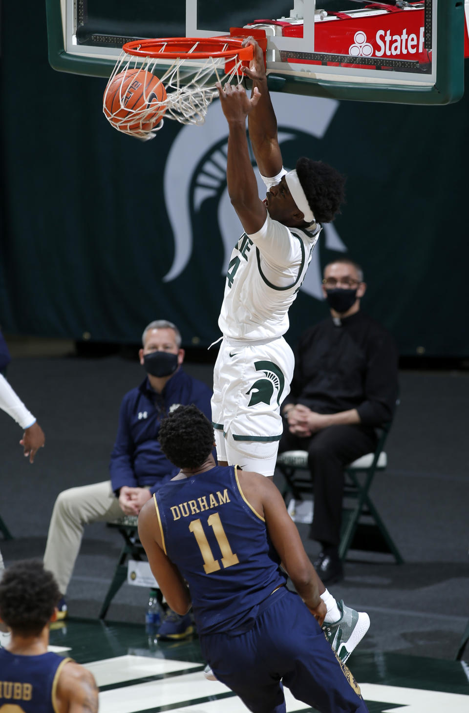 Michigan State's Gabe Brown dunks over Notre Dame's Juwan Durham (11) during the first half of an NCAA college basketball game Saturday, Nov. 28, 2020, in East Lansing, Mich. (AP Photo/Al Goldis)