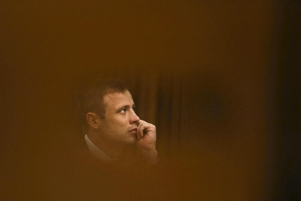 FILE - Oscar Pistorius listens Thursday, Oct. 16, 2014 in the high court for the fourth day of sentencing in Pretoria, South Africa. Pistorius shot his girlfriend Reeva Steenkamp more than a decade ago in a Valentine's Day killing that jolted the world and shattered the image of a sports superstar. (AP Photo/Alon Skuy, Pool, File)