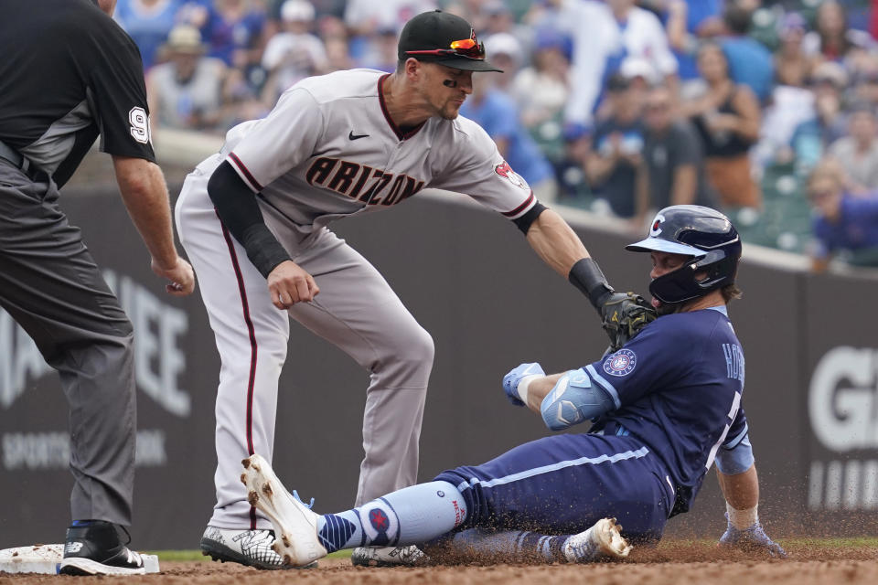 Arizona Diamondbacks shortstop Nick Ahmed tags out Chicago Cubs' Nico Hoerner, right, at second base after Hoerner hit a two-run single during the third inning of a baseball game in Chicago, Friday, July 23, 2021. (AP Photo/Nam Y. Huh)