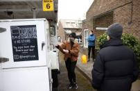 Ella Shone, serves customers from her mobile zero waste shop called the 'Top Up Truck' in London