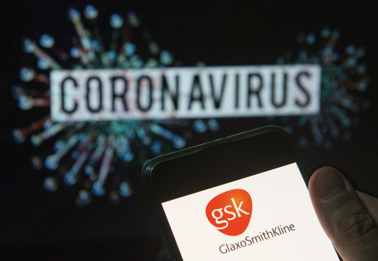 CHINA - 2020/03/23: In this photo illustration the British multinational pharmaceutical company GlaxoSmithKline (GSK) logo seen displayed on a smartphone with a computer model of the COVID-19 coronavirus on the background. (Photo Illustration by Budrul Chukrut/SOPA Images/LightRocket via Getty Images)