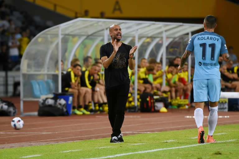 Manchester City's head coach Pep Guardiola applauds his team's 2016 International Champions Cup football match against Borussia Dortmund in Shenzhen, on July 28, 2016