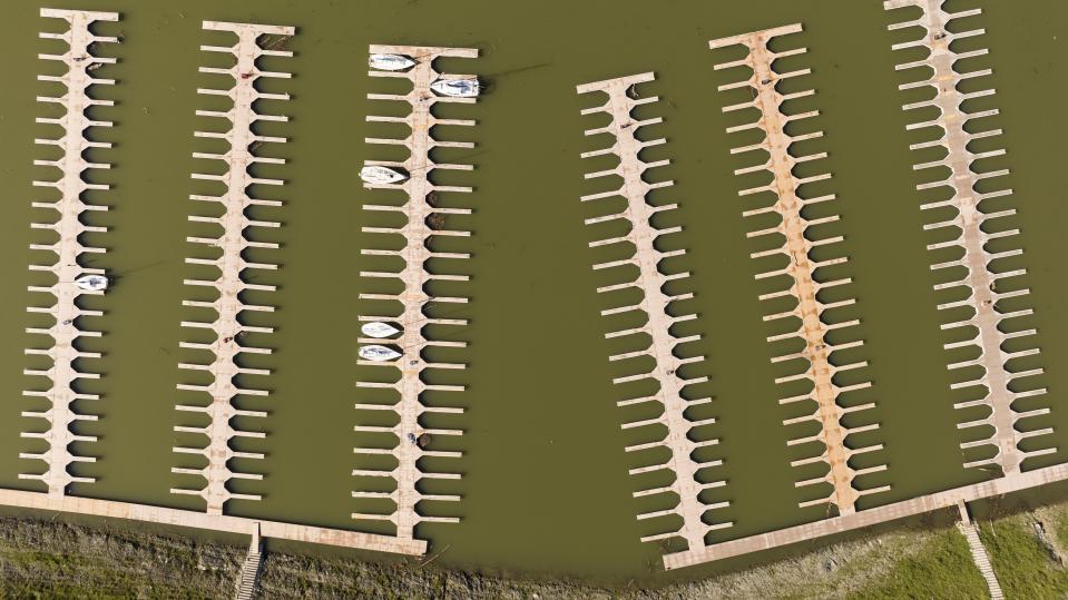 Docks float in the Browns Ravine Cove area of Folsom Lake in Folsom, Calif., on Sunday, March 26, 2023. Months of winter storms have replenished California's key reservoirs after three years of punishing drought. (AP Photo/Josh Edelson)