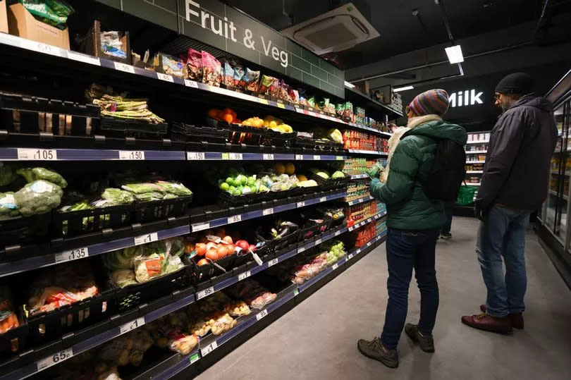 Shoppers buy fruit and veg at an Asda Express convenience store