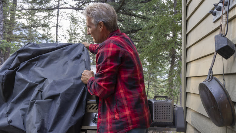 man covering his grill