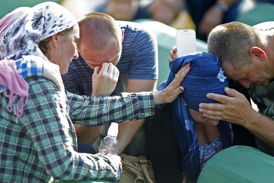 Bosnian Muslims cry near the coffin of a relative before a mass funeral for bodies found in a mass grave, in Kozarac, near Prijedor, July 19, 2014. (REUTERS/Dado Ruvic)