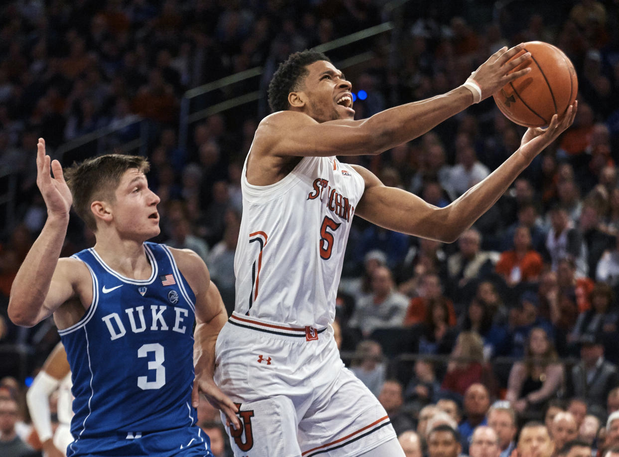 St. John’s Justin Simon (5) drives to the basket past Duke’s Grayson Allen (3) during the first half of an NCAA college basketball game at Madison Square Garden in New York, Saturday, Feb. 3, 2018. (AP Photo/Andres Kudacki)