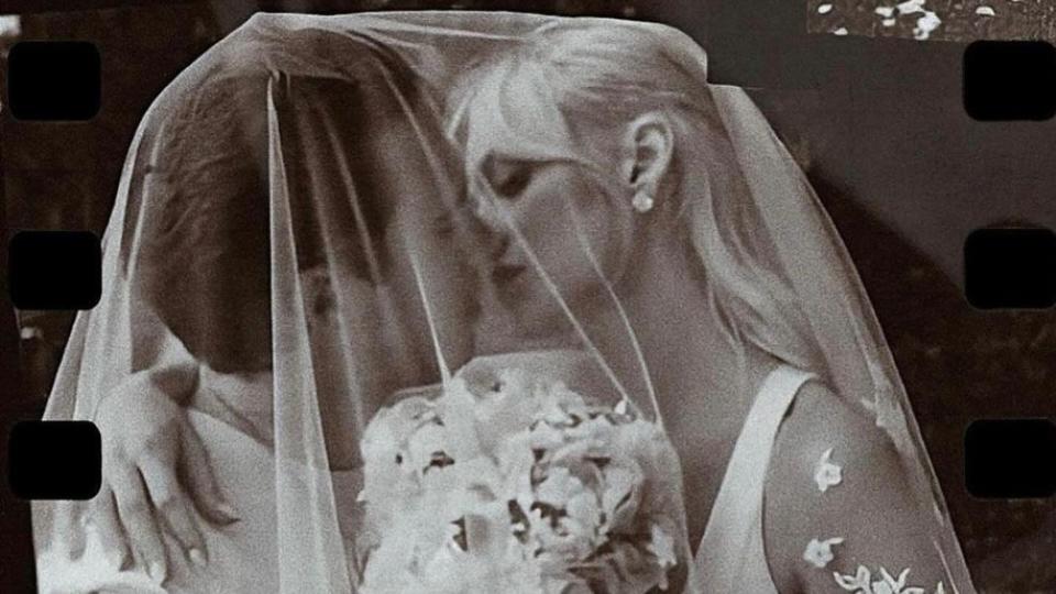 Nicola and Brooklyn Peltz-Beckham share a kiss under a veil