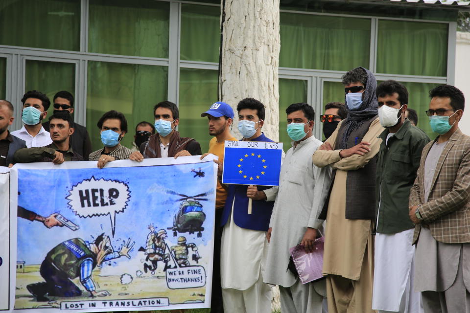 In this Friday, April 30, 2021, photo former Afghan interpreters hold placards during a protest against the U.S. government and NATO in Kabul, Afghanistan. / Credit: Mariam Zuhaib / AP