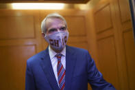 Sen. Rob Portman, R-Ohio, departs the Senate as lawmakers work to advance the $1 trillion bipartisan infrastructure bill, at the Capitol in Washington, Monday, Aug. 2, 2021. The 2,700-page bill includes new expenditures on roads, bridges, water pipes broadband and other projects, plus cyber security. (AP Photo/J. Scott Applewhite)