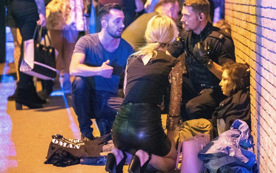 Victims of the Manchester attack are tended to outside the arena - Credit: Joel Goodman/L