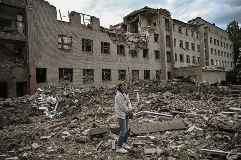 A woman stands in front of an administrative building shelled by the Russians in Bakhmut in the eastern Ukraine region of Donbas (AFP via Getty)