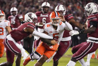 Clemson quarterback D.J. Uiagalelei (5) runs with the ball against South Carolina defensive back Cam Smith, left, during the first half of an NCAA college football game Saturday, Nov. 27, 2021, in Columbia, S.C. (AP Photo/Sean Rayford)