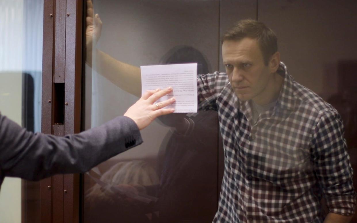 Alexei Navalny at his court hearing in Moscow, where he told the court he had no regrets about going back to Russia to a sure imprisonment  - REUTERS