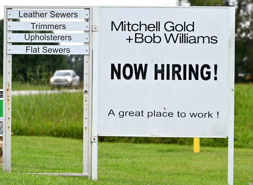 The Mitchell Gold + Bob Williams furniture company based in Taylorsville, N.C., closed abruptly in August with over 530 job cuts. Along with signs from other companies hiring, Mitchell Gold’s still has a sign at the Taylorsville facility that says “Now Hiring!” JEFF SINER/jsiner@charlotteobserver.com