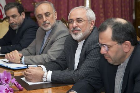 Iran's Foreign Minister Javad Zarif (2nd R), with the head of the Atomic Energy Organisation of Iran Ali Akbar Salehia (2nd L) at his side, sits at the negotiating table for a meeting with United States Secretary of State John Kerry (not pictured) over Iran's nuclear program in Lausanne March 20, 2015. REUTERS/Brian Snyder