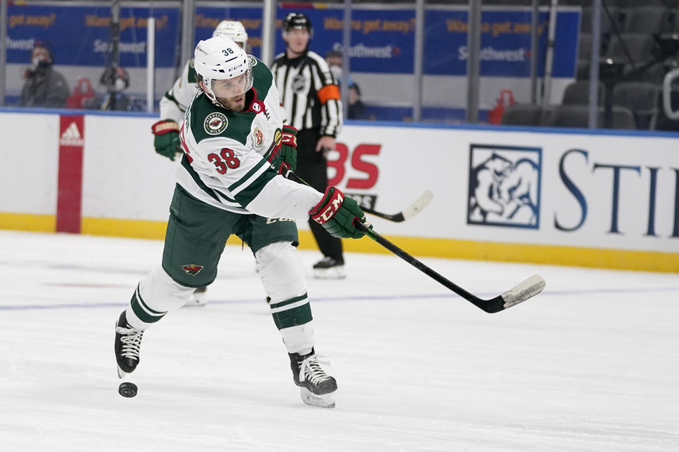 Minnesota Wild's Ryan Hartman misses the puck during the first period of an NHL hockey game against the St. Louis Blues Friday, April 9, 2021, in St. Louis. (AP Photo/Jeff Roberson)