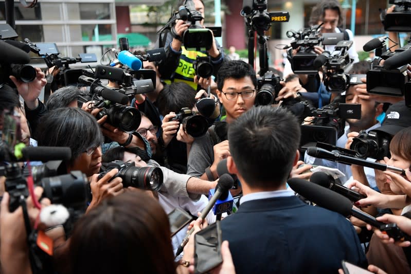 Disqualified candidate and pro-democracy activist Joshua Wong speaks to the media before voting in district council elections in Hong Kong