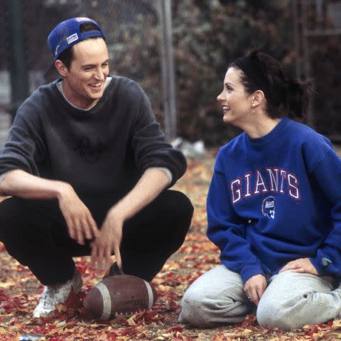 <p>Gary Null/NBCU Photo Bank</p> "The One with the Football" Episode 6 -- Pictured: (l-r) Matthew Perry as Chandler Bing, Courteney Cox Arquette as Monica Geller.