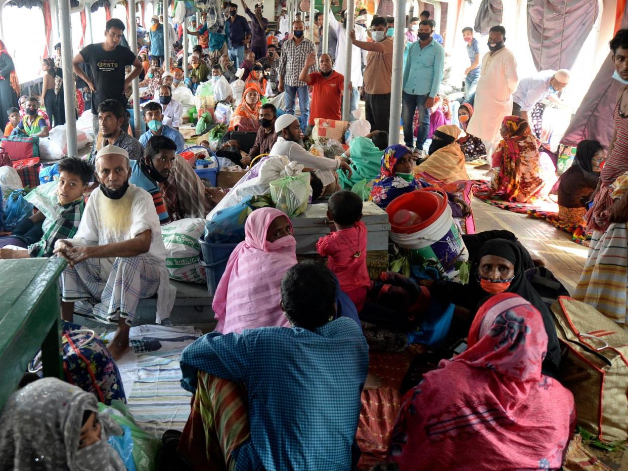 Passengers sit in a crowded ferry in Dhaka, Bangladesh, on their way back home, 1 June, 2020: AFP via Getty Images