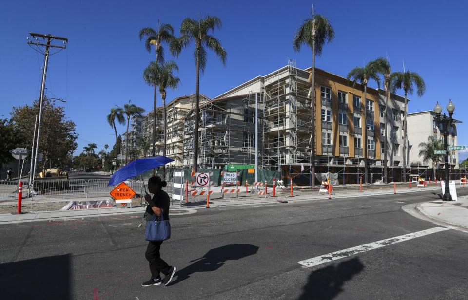 A pedestrian near the O.C. Streetcar construction site in Santa Ana