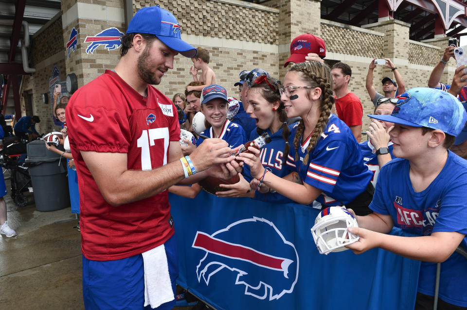 FILE - Buffalo Bills quarterback Josh Allen (17) signs a bottle of barbecue sauce for a fan after practice at the NFL football team's training camp in Pittsford, N.Y., Thursday, July 27, 2023. Allen has become accustomed to having his public life picked over and documented with his star status in Buffalo and beyond showing no signs of cresting. (AP Photo/Adrian Kraus, File)