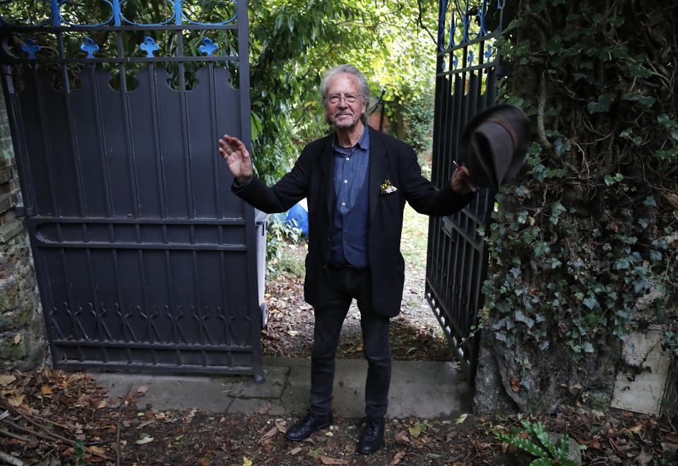 Austrian author Peter Handke gestures as he arrives back at his house in Chaville near Paris, Thursday, Oct. 10, 2019. Handke was awarded the 2019 Nobel Prize in literature earlier Thursday. (AP Photo/Francois Mori)