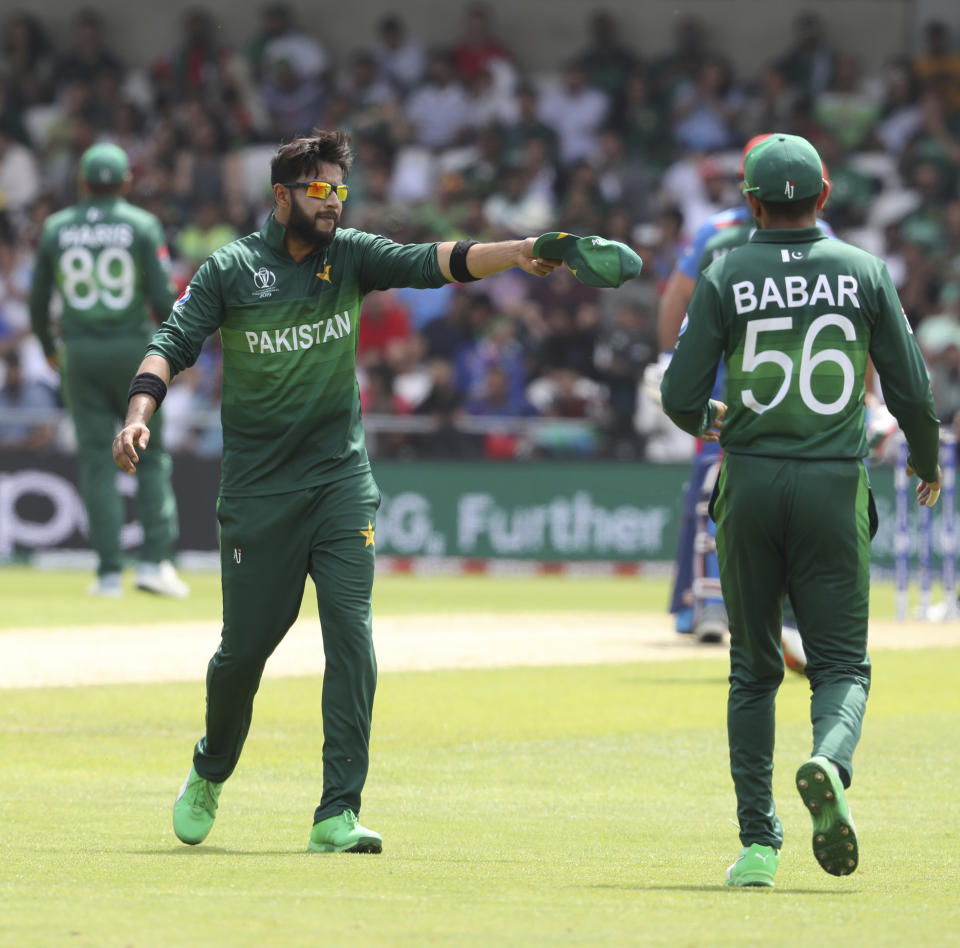 Pakistan's Imad Wasim, left, speaks with Pakistan's Babar Azam during the Cricket World Cup match between Pakistan and Afghanistan at Headingley in Leeds, England, Saturday, June 29, 2019. (AP Photo/Rui Vieira)