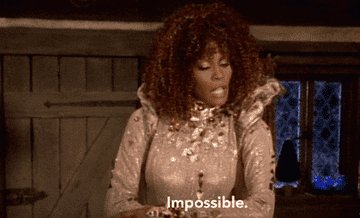 Whitney Houston as the fairy god mother with the word "Impossible."