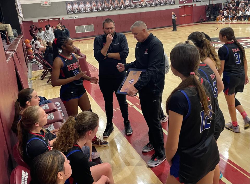 King’s Academy girls basketball coach Chris Race goes over a play with his team in the second half of Thursday night’s Class 3A regional final at Seffner Christian Academy. King’s, the two-time defending regional champs, lost to the host Crusaders, 47-42.