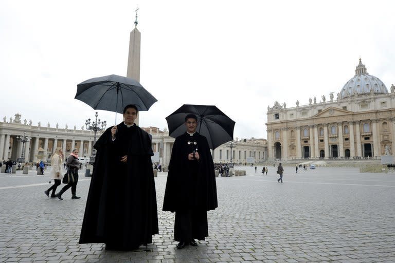 Priests in St Peter's Square at the Vatican after it was announced Pope Benedict XVI will resign on February 11, 2013