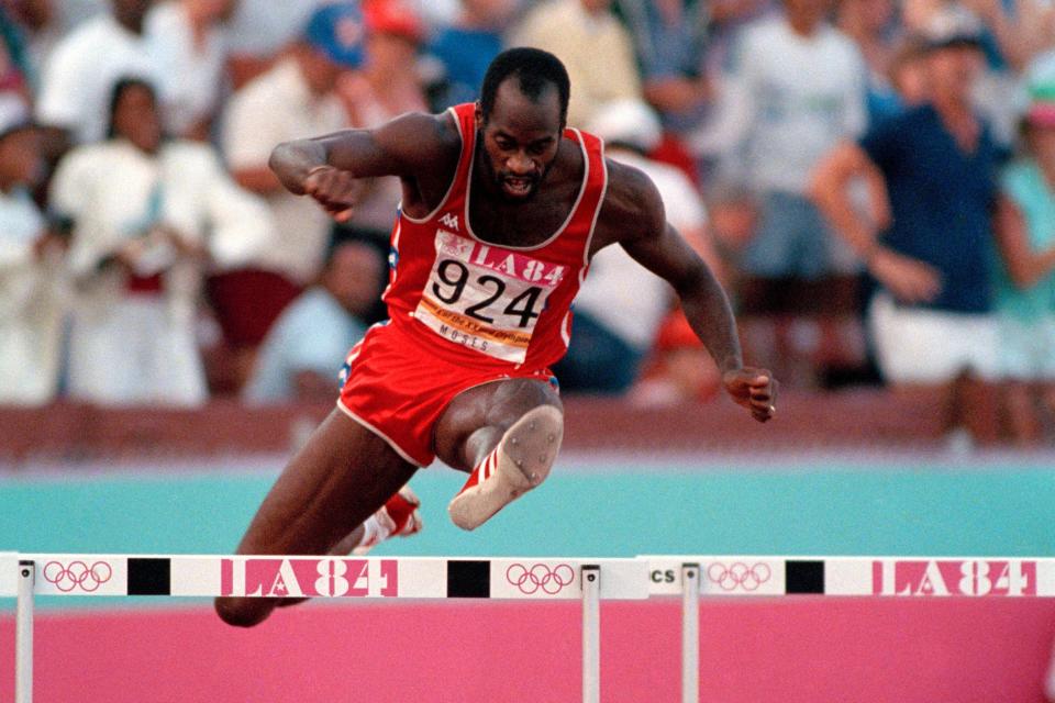 In this Aug. 5, 1984, file photo, United States' Edwin Moses jumps a hurdle on his way to winning the gold medal in the 400-meter hurdles at the Summer Olympic Games in Los Angeles.